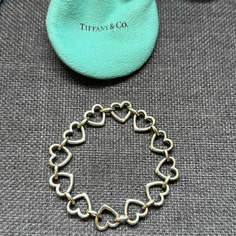 Tiffany & Co.  Rare clasping hearts charm bracelet